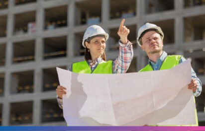 Team of engineers planning a construction project with blueprints and digital models