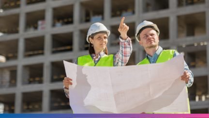 Team of engineers planning a construction project with blueprints and digital models